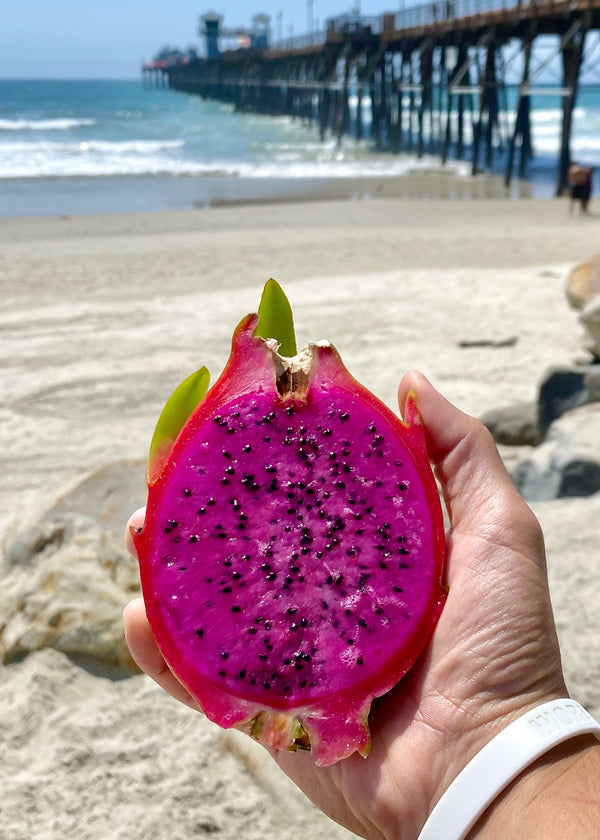 Purple Haze dragon fruit cut open, bright magenta flesh